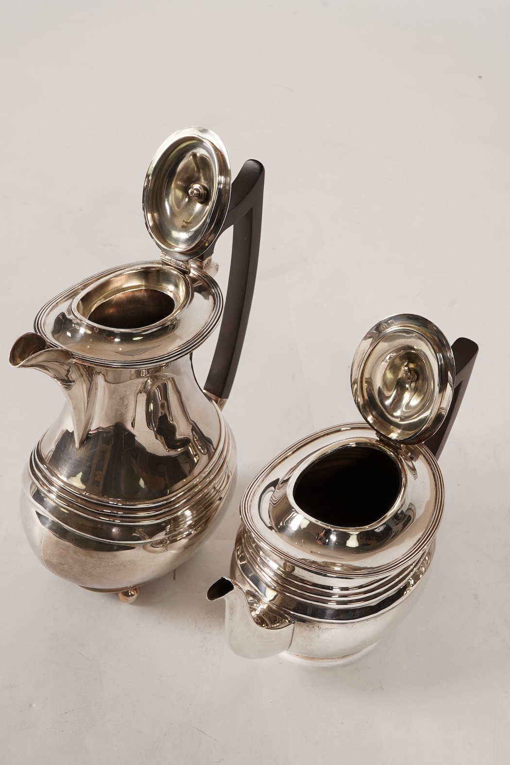 A George V four piece silver tea set, comprising teapot, hot water pot, sugar bowl and milk jug, by S. Blanckensee & Son Ltd